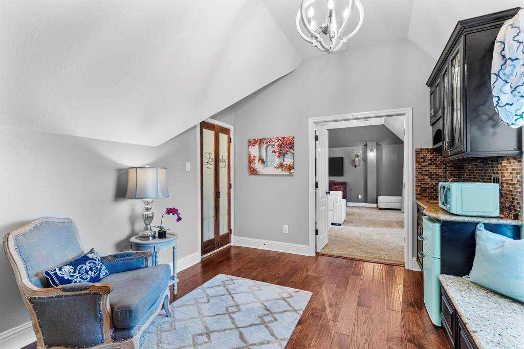 Right off the media room is the wet bar area with access to the upstairs laundry room.