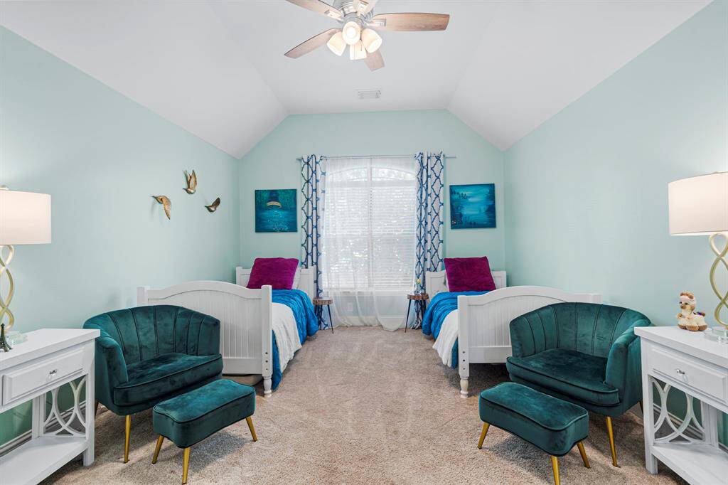 Third bedroom features a large window, ceiling fan, custom paint, and plush carpet.