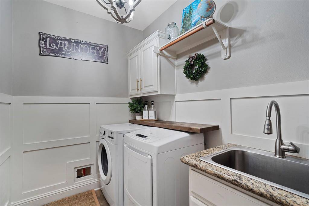 The downstairs laundry room features washer and dryer connections, stainless steel sink, andplenty of storage space.