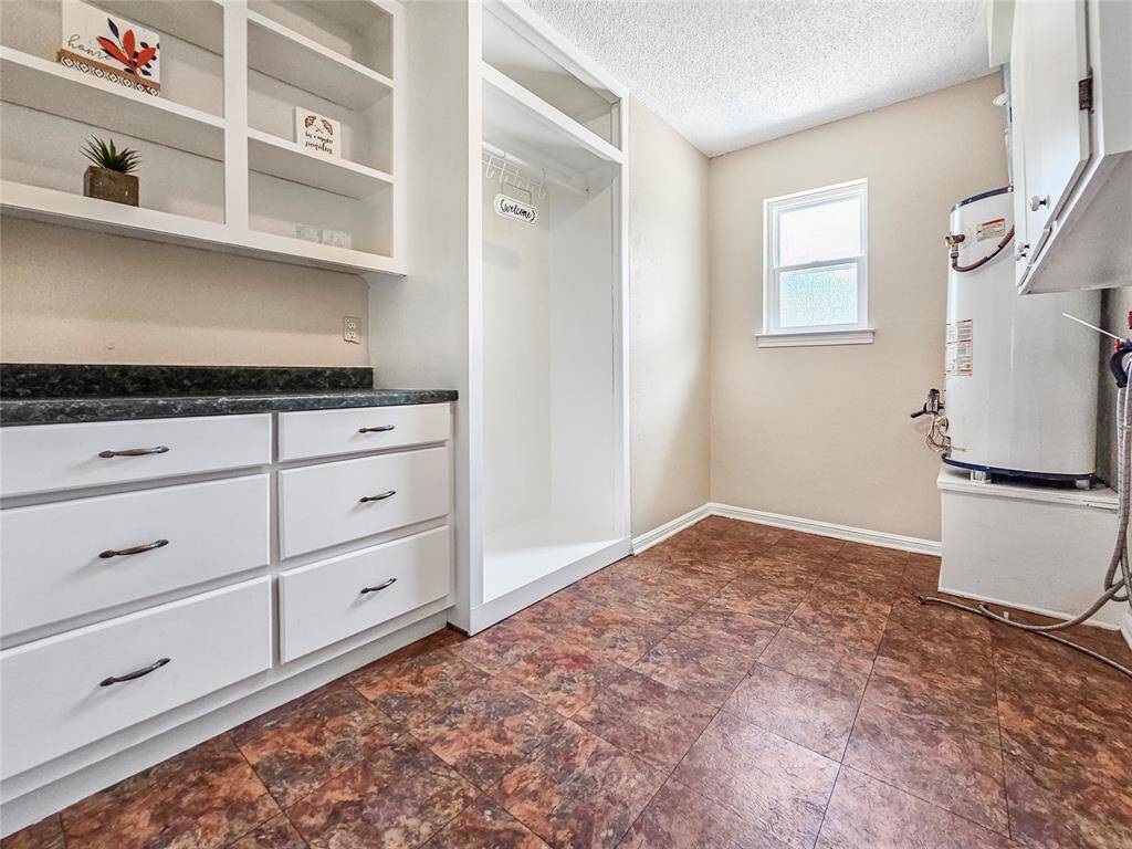 Large Laundry Room with storage space and area to hang clothing