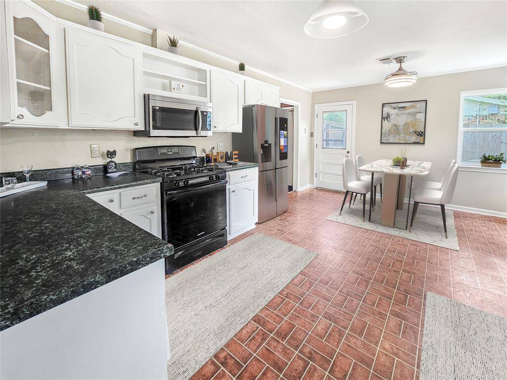 Open Kitchen and dining area with plenty of counterspace and storage. Customizable Walk-in Pantry area next to the refrigerator. - VIRTUALLY STAGED