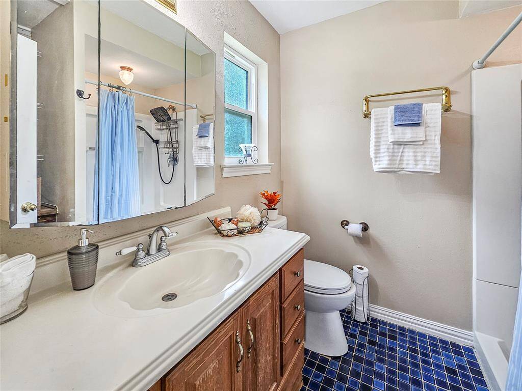 Primary Bath with ample lighting and spa shower fixture