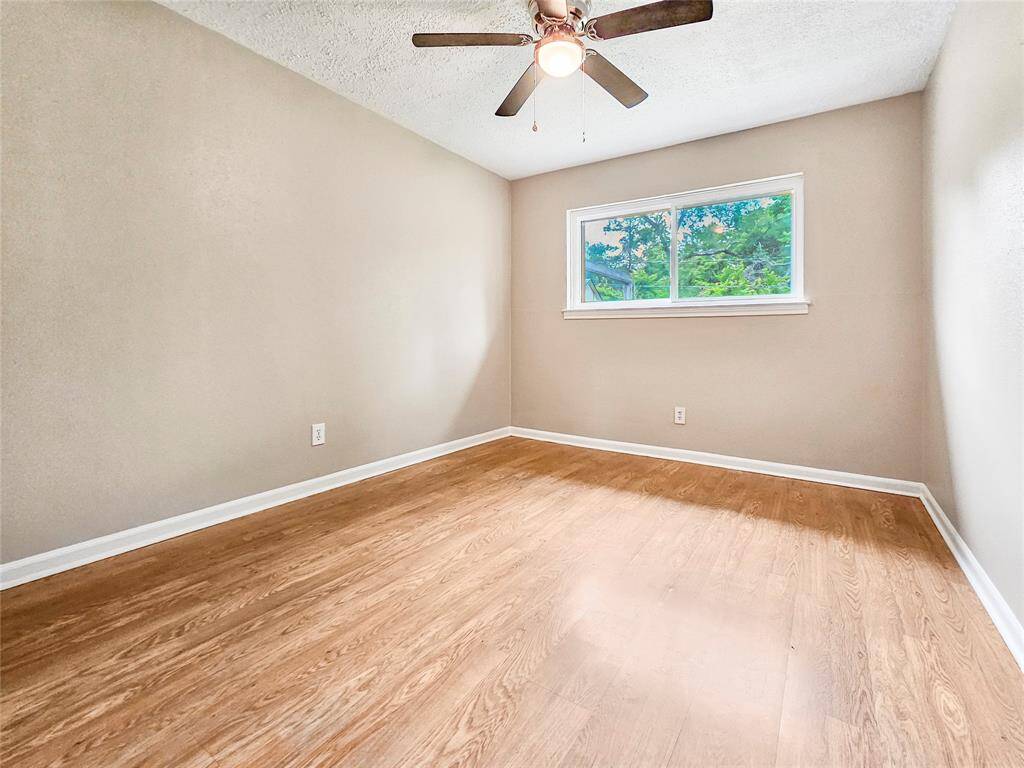 Second bedroom with ceiling fan light fixture and plenty of storage
