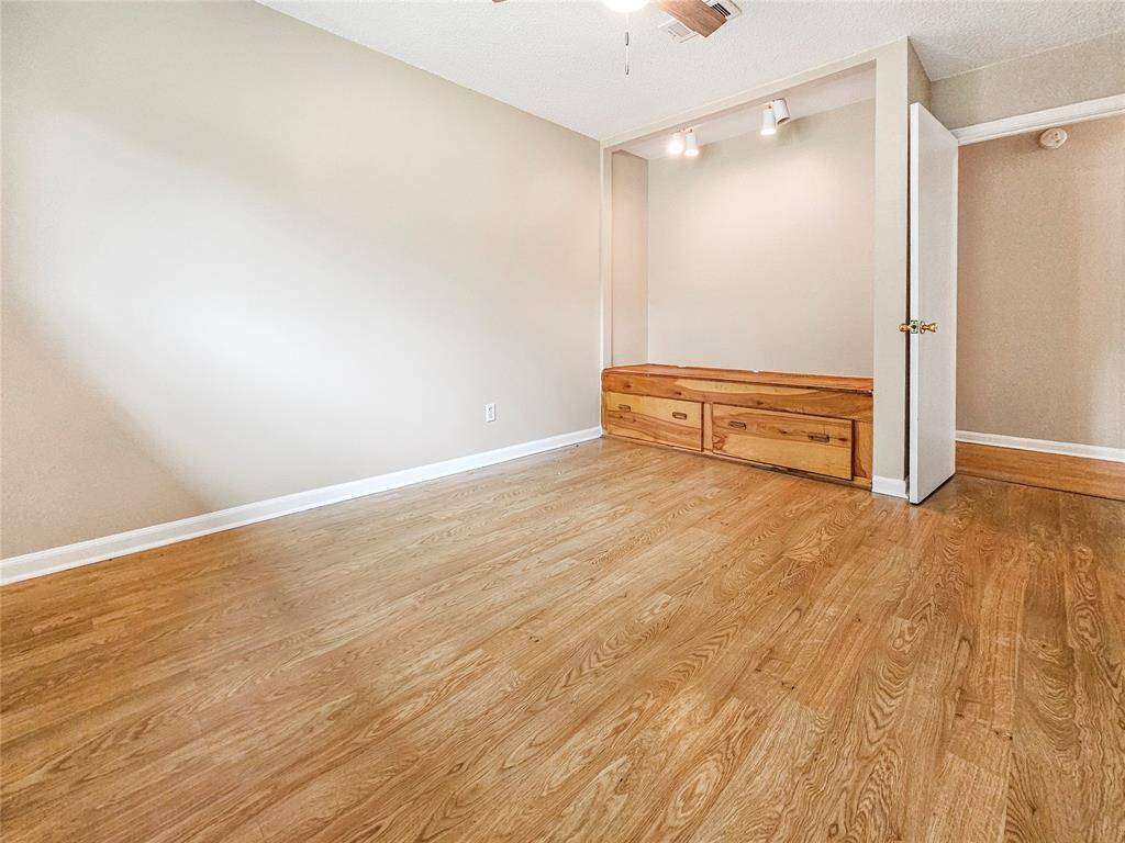 Third bedroom with ceiling fan light fixture, plenty of natural light