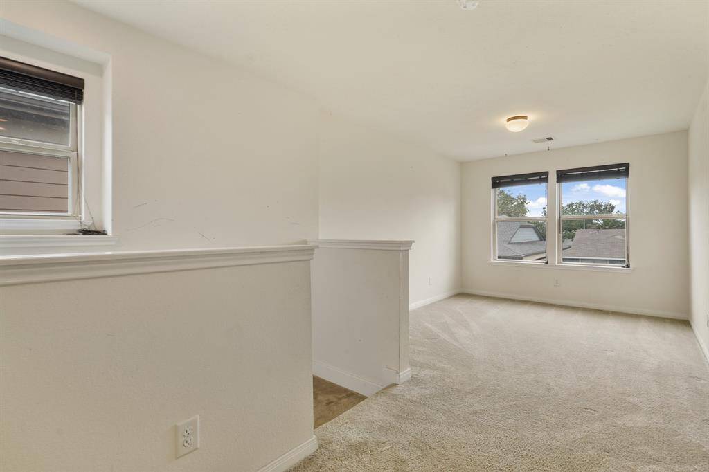 Conveniently upstairs is this fabulous game room! Complete with plush carpet, and large windows.