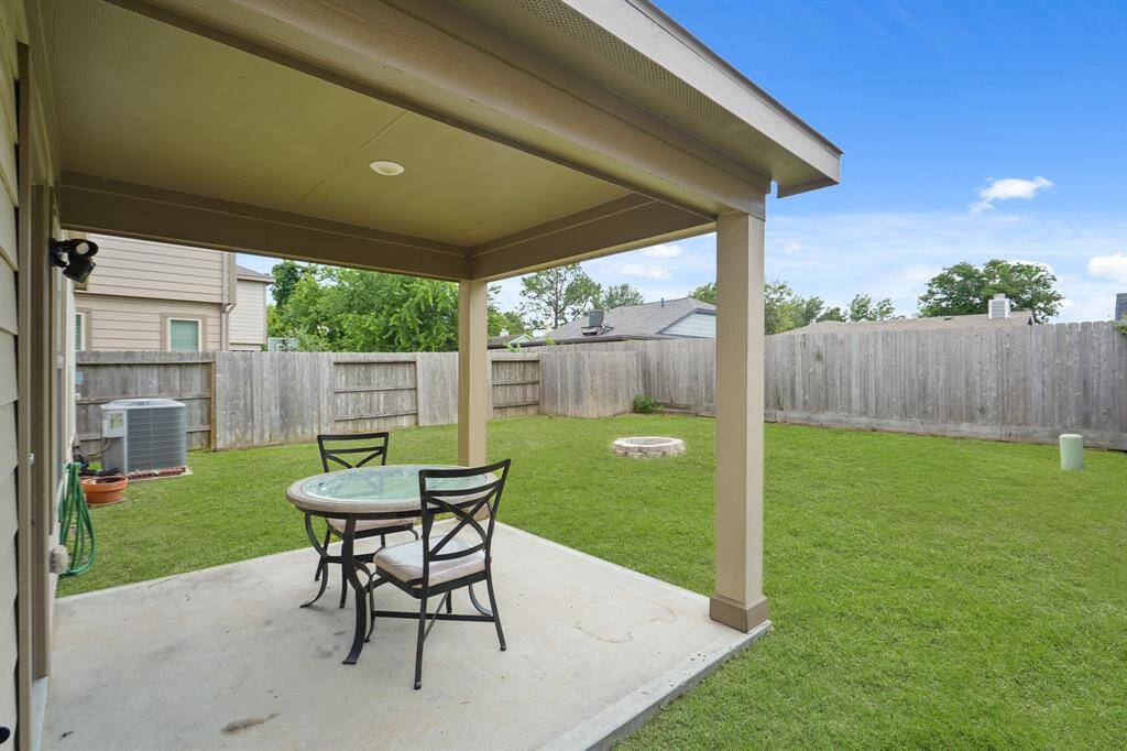 This backyard features a great patio perfect for outdoor seating and dining.