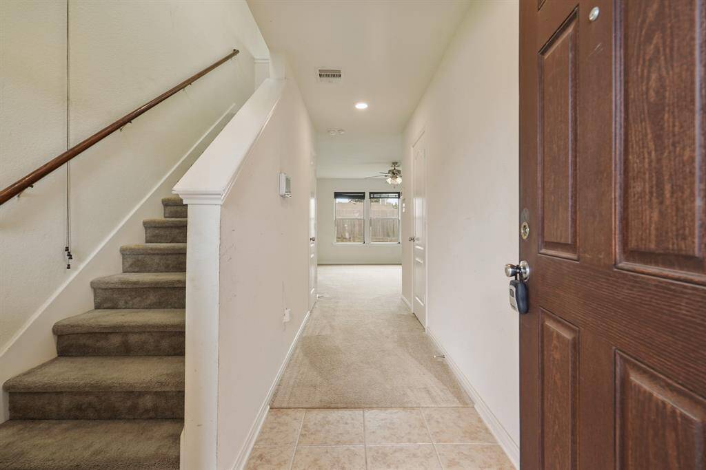 You'll be instantly greeted by tile and carpet floors, and a charming stair case.