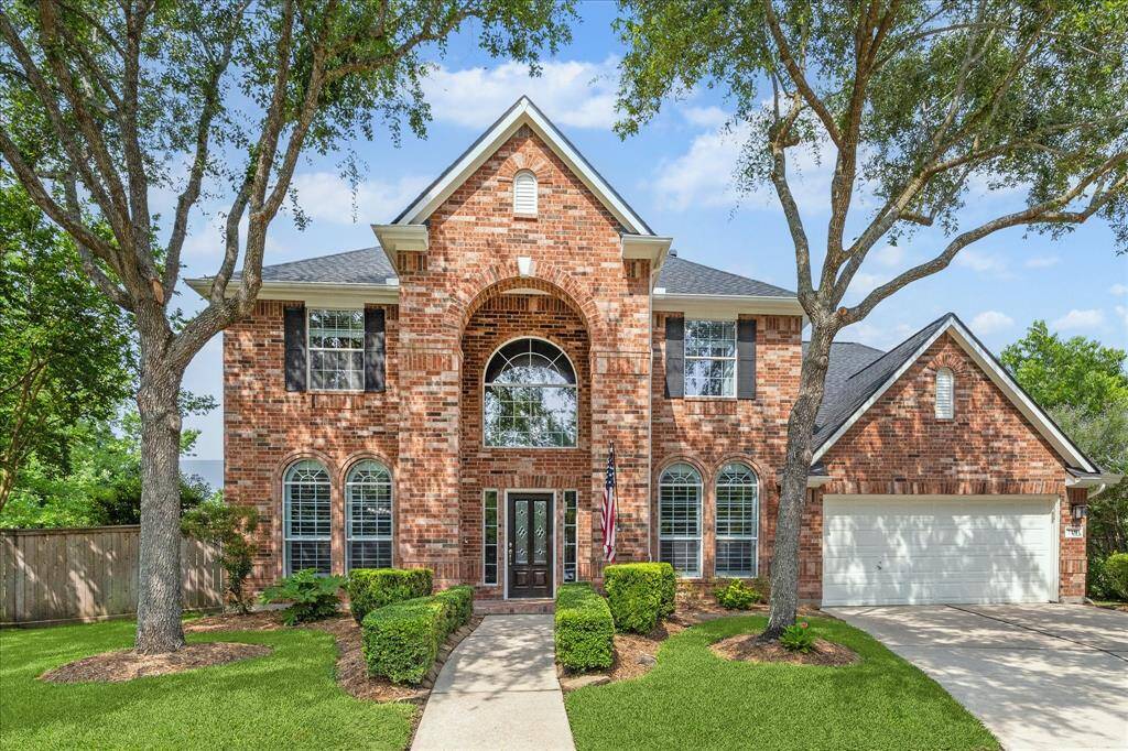 Impressive curb appeal with grand entrance and double driveway.