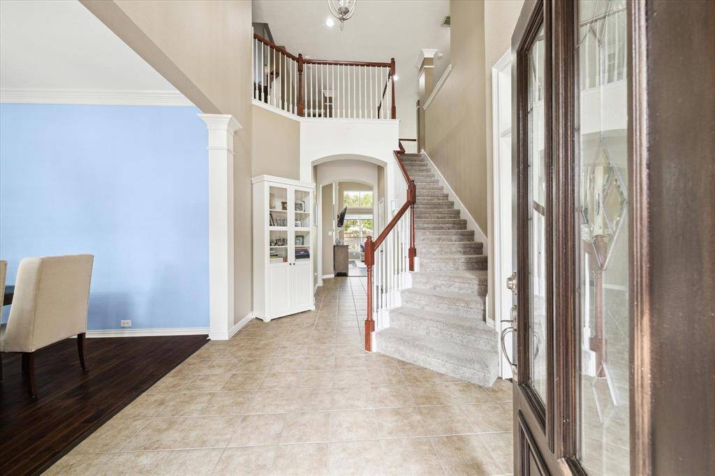 Grand entryway with arched openings and tile flooring.