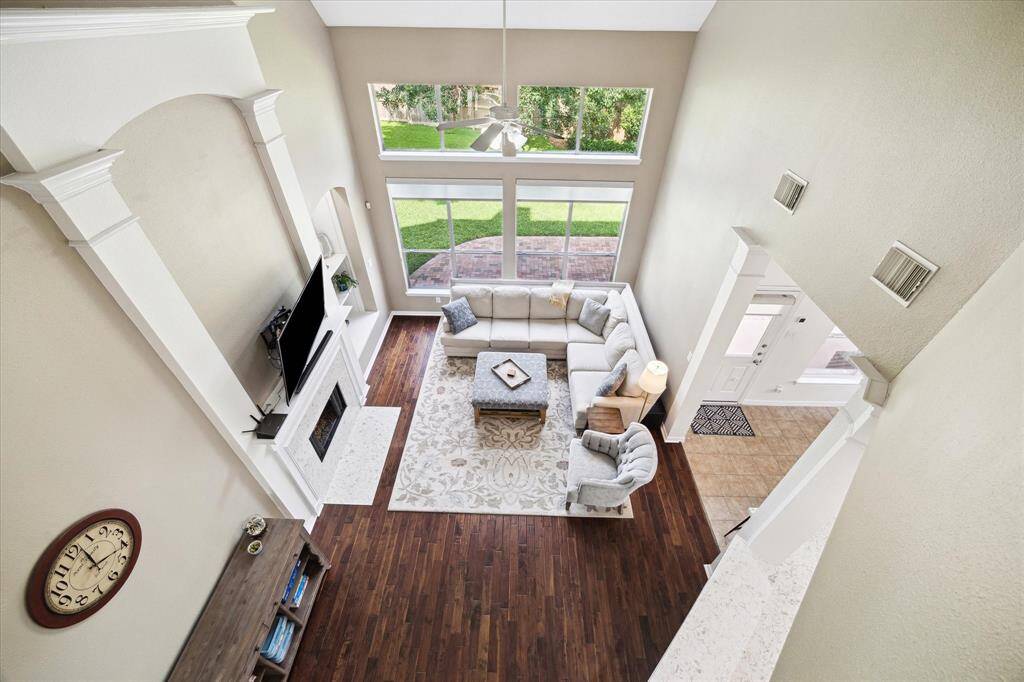 Grand living with fireplace and soaring ceilings.