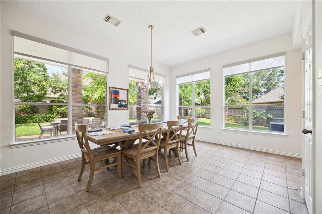 Expansive breakfast  room with backyard views and natural light.