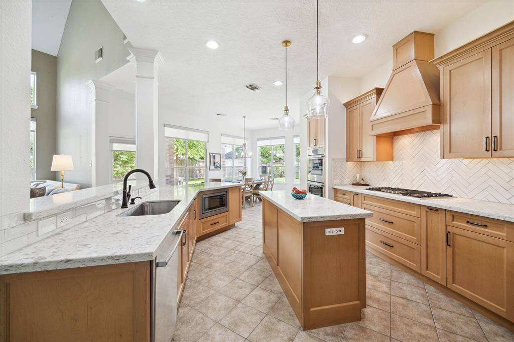 This newly completed, custom cabinetry designed chef’s kitchen combines function and style with a statement stone island, herringbone tile, and premium finishes—perfectly crafted for cooking and entertaining.