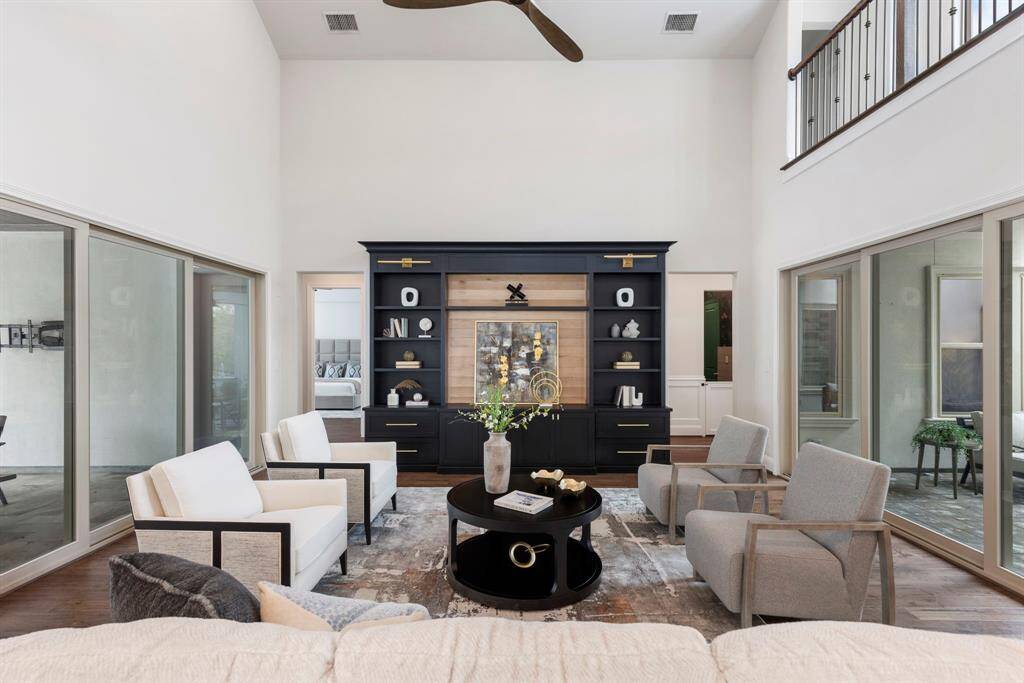 Main living room with full wall glass sliding doors on either side.