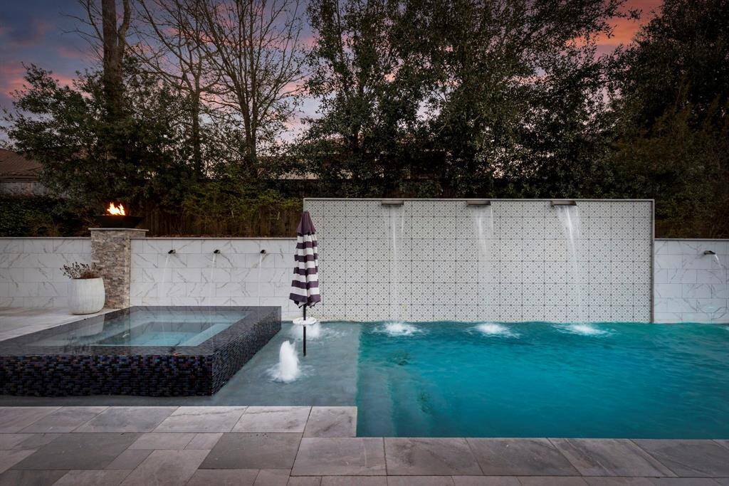 Engineered privacy wall, contemporary water falls, and fire bowls