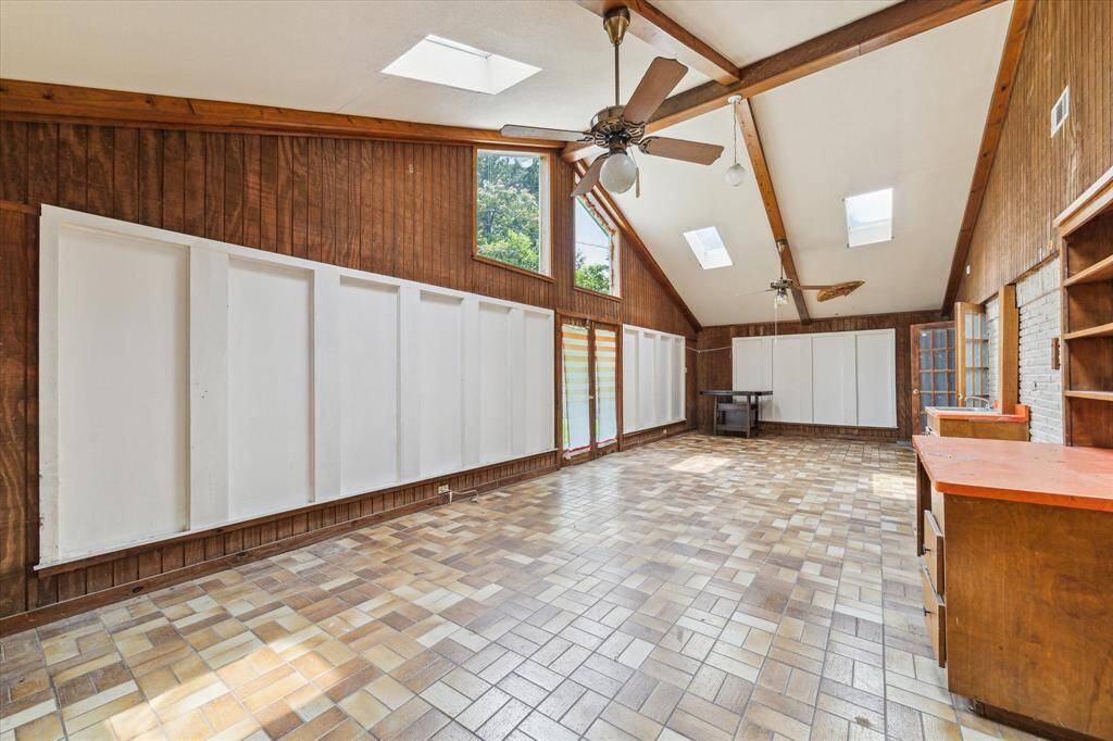 Spacious Sunroom with skylight windows for natural lighting