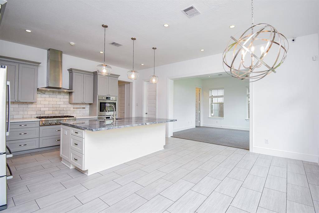 Kitchen with eating area and view of den.