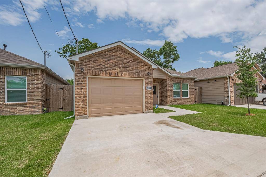 Charming brick single-story home with a neatly manicured lawn and a spacious driveway leading to an attached garage. The property is in a nice neighborhood with similar houses, offering a welcoming and well-maintained exterior.