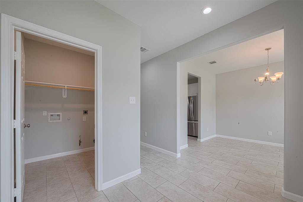 This home features elegant light tile flooring, complemented by modern light gray walls and crisp white trims.