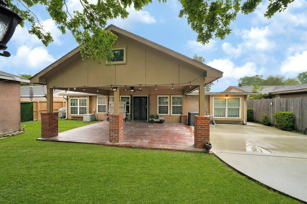 Back yard with extended covered patio.