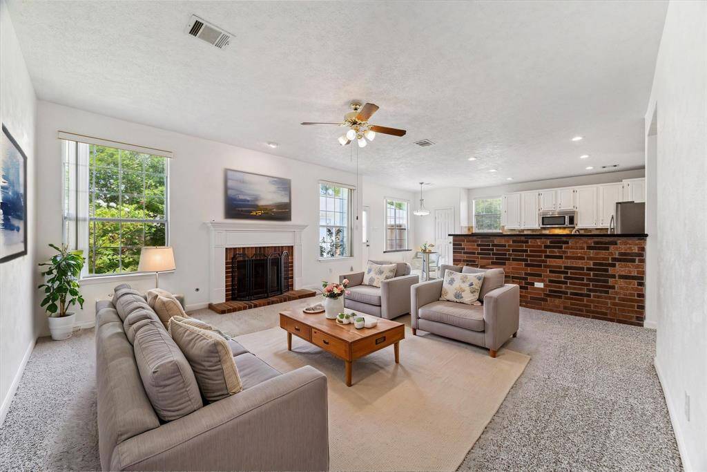 COZY FAMILY ROOM WITH A BRICK FIREPLACE AND MANTEL—A PERFECT GATHERING SPOT. **This room has been virtually staged.