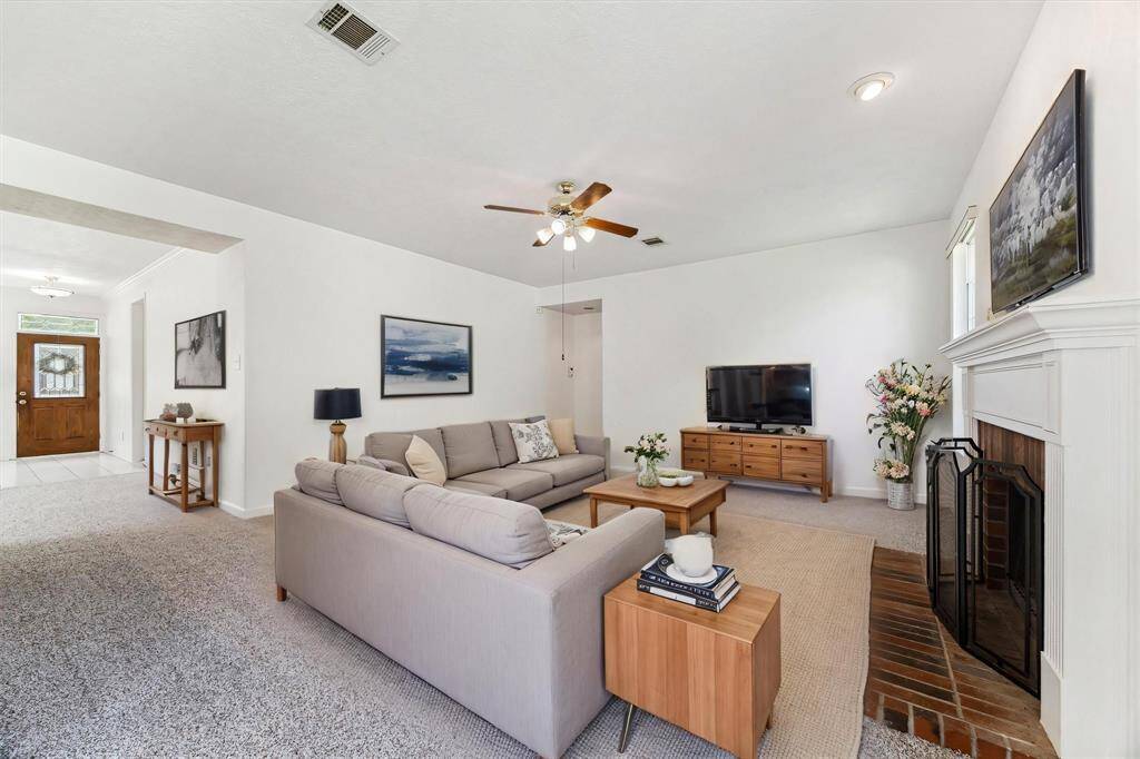 FAMILY ROOM WITH AMPLE SPACE FOR ENTERTAINING, OPEN TO DINING AND KITCHEN AREAS. **This room has been virtually staged.