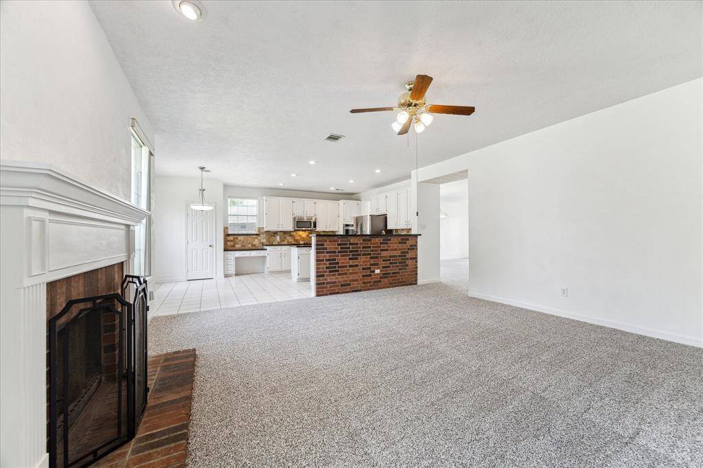 OPEN FLOOR PLAN WITH CONNECTED KITCHEN, DINING, AND LIVING AREAS FOR EASY FLOW.