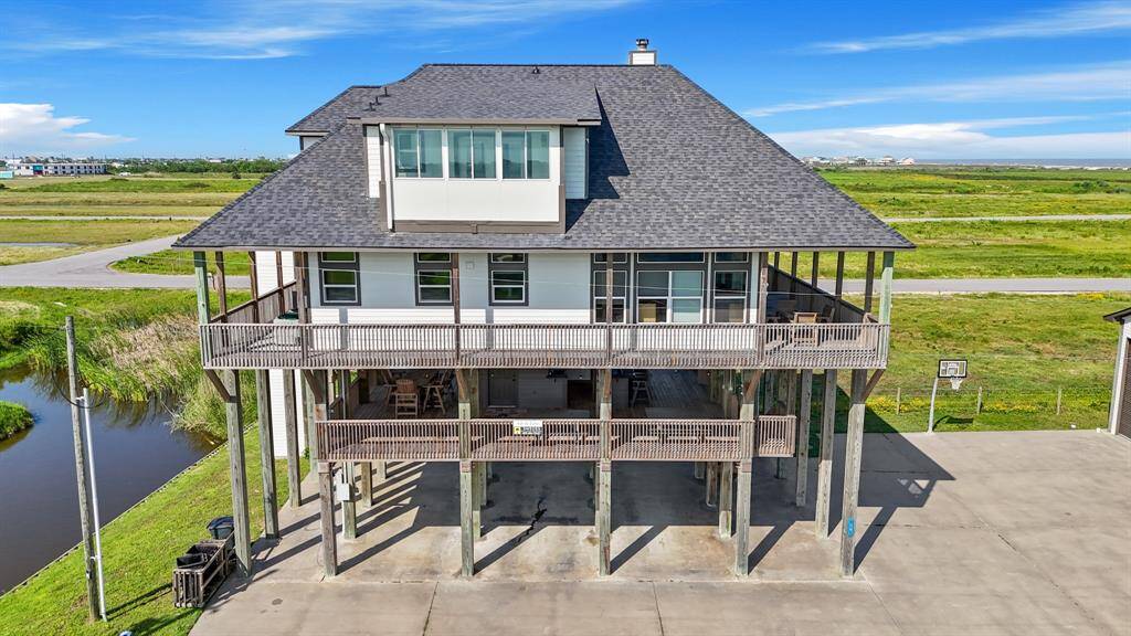 Raised construction offers peace of mind and style, with expansive covered decks on both levels—perfect for enjoying the sea breeze and outdoor living.
