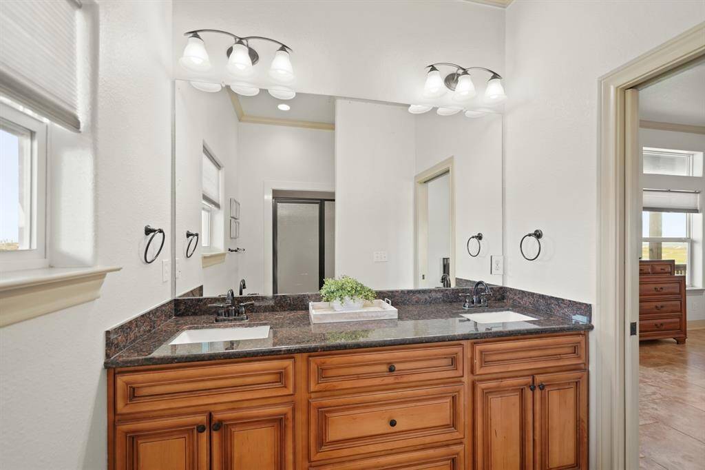 The primary bath connects seamlessly to the bedroom and includes thoughtful finishes and quality craftsmanship throughout.