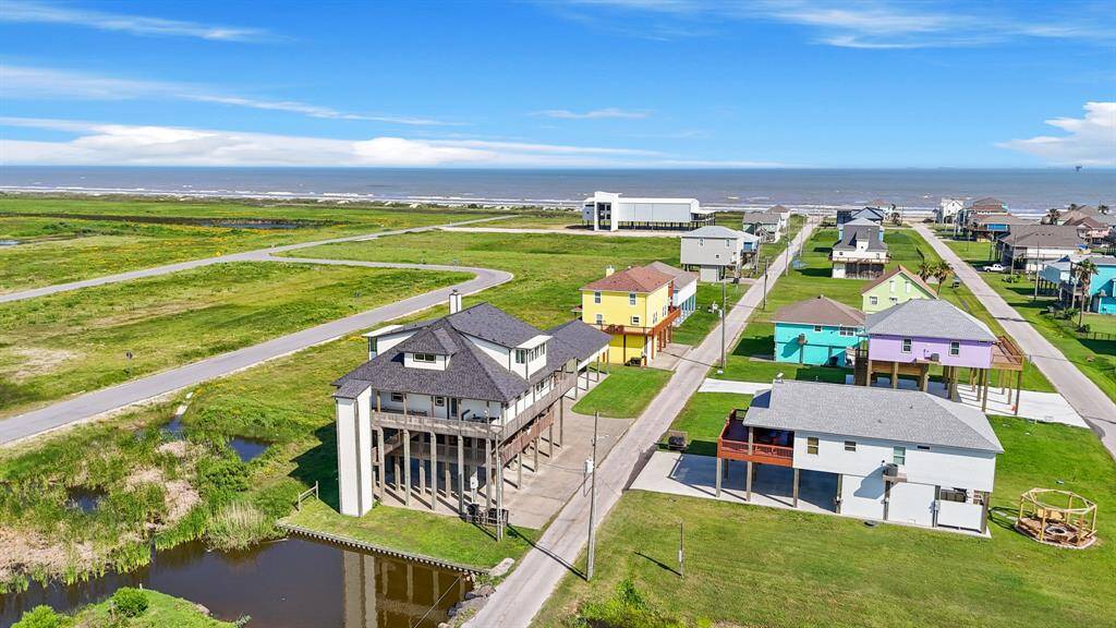 Spectacular aerial view shows the home just moments from the beach greenbelt space and unobstructed water views.