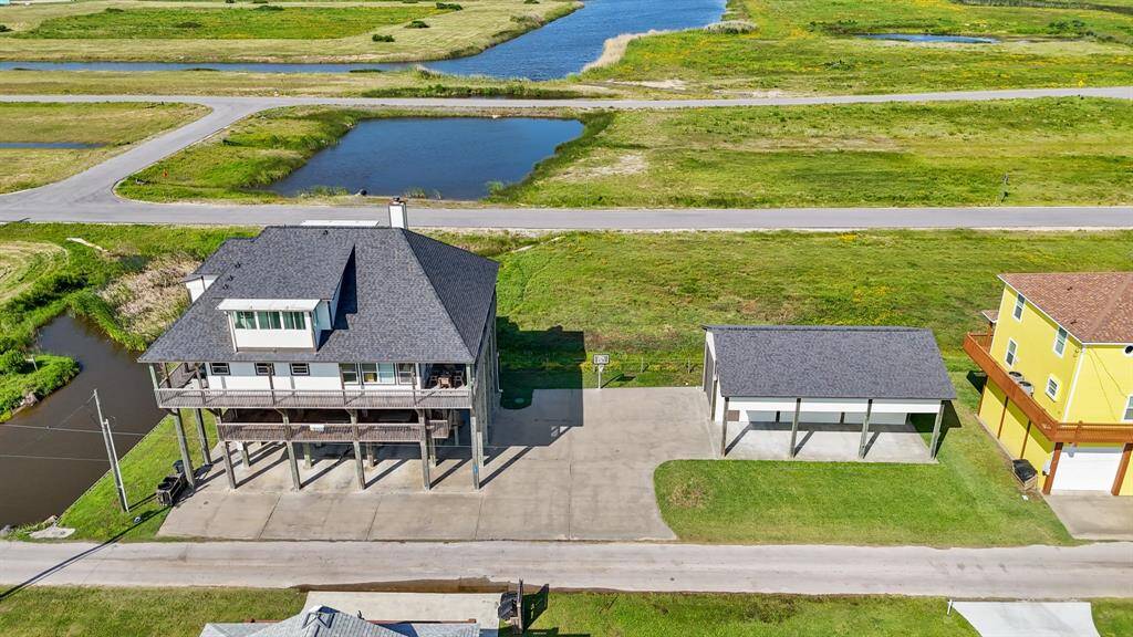 Bird’s-eye view showcases the oversized lot, large driveway, and additional detached structure—ideal for boat storage or workshop use.