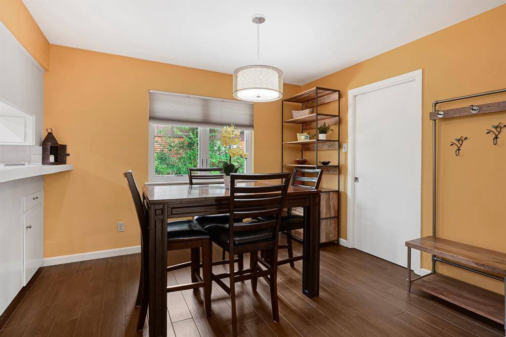 The spacious Breakfast Area includes a modern light fixture, large window for natural light, and leads to the Utility Room.