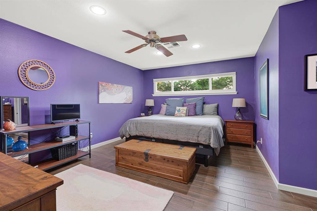 A second view of the luxurious primary bedroom. While not visible, the home offers enhanced comfort thanks to upgraded blown-in attic insulation and double-pane windows, for a quiet, energy-efficient environment.