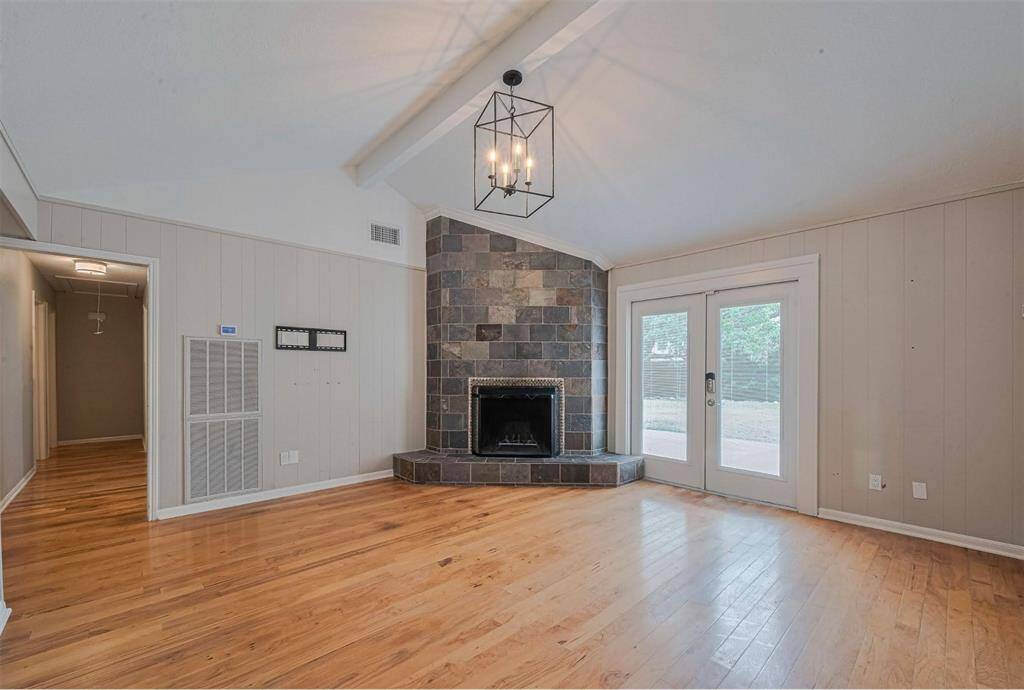 What a great living space, with a vaulted ceiling and french doors leading to the patio.