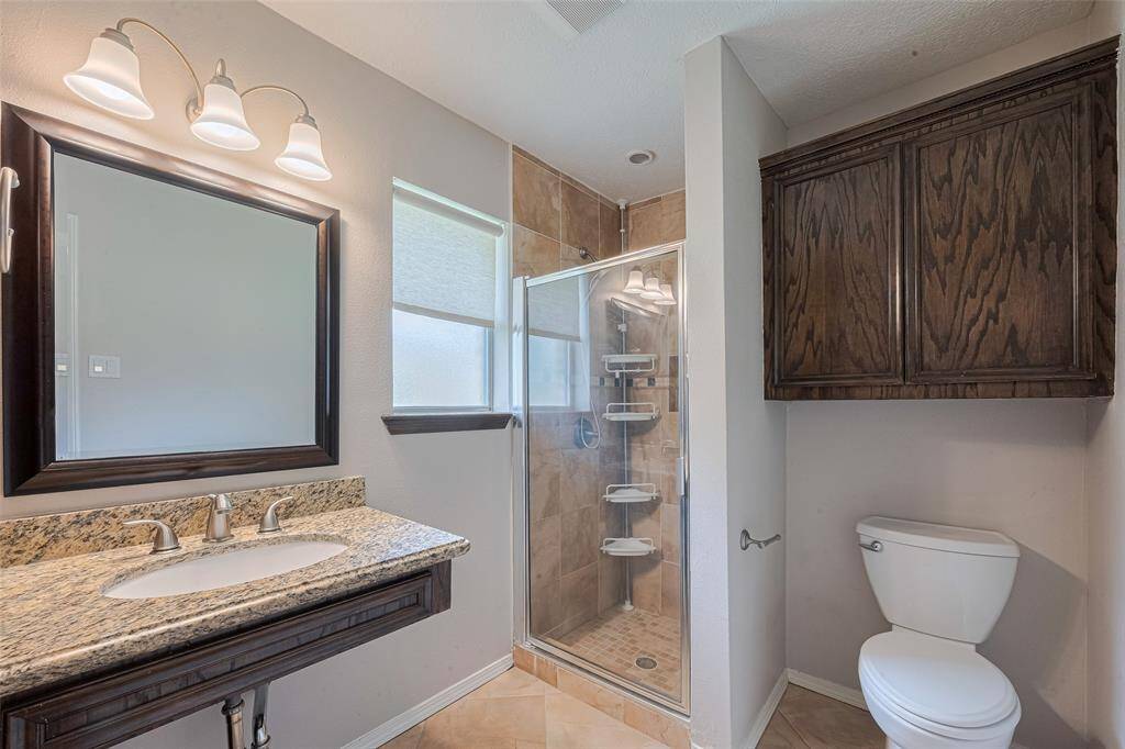 The primary bath is updated with ample storage.
