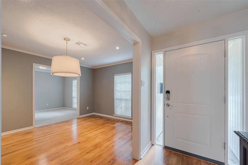 The bright entryway welcomes you inside and opens to the dining and living spaces.