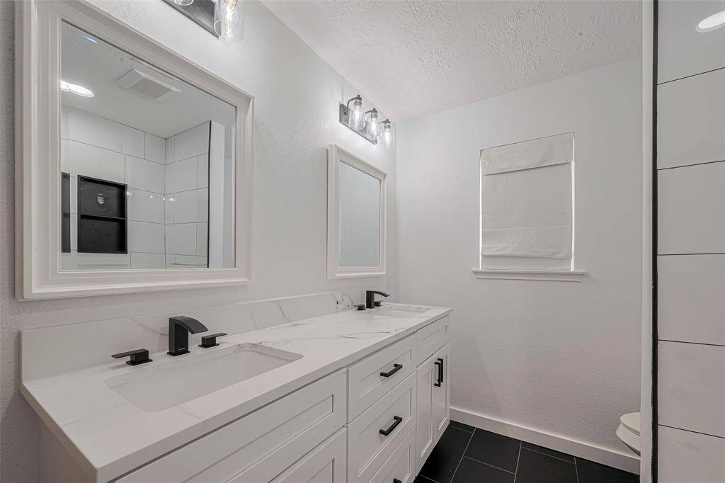 The secondary bath was recently remodeled with new cabinets, counters, fixtures, and tile.