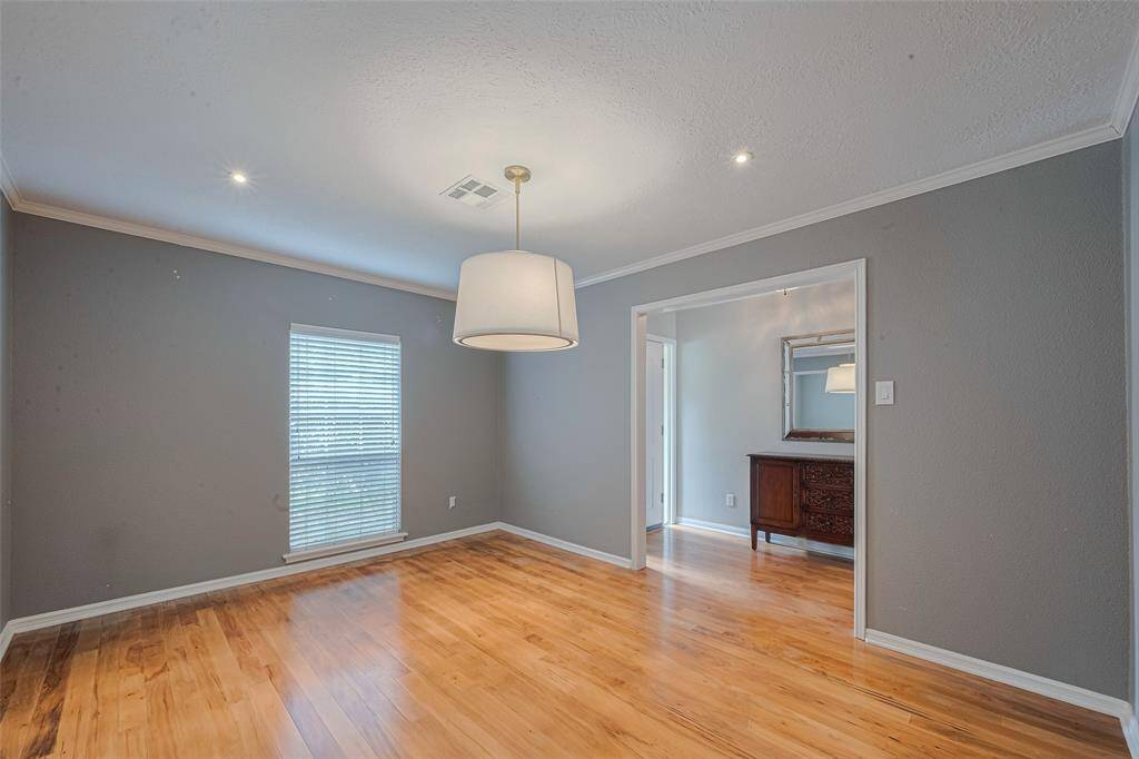 A large window, recessed lighting, and a beautiful light fixture create a warm environment.