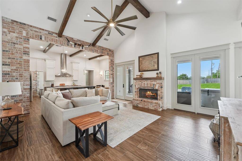 Inviting living area with pool views and gas log fireplace.