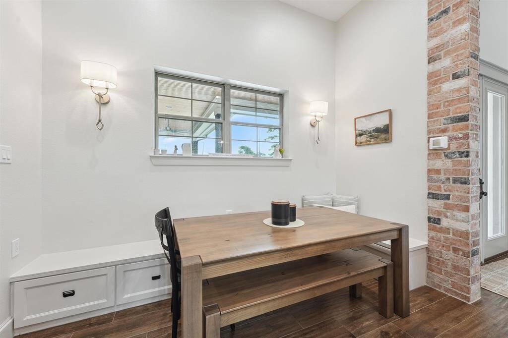 Dining area conveniently located just off kitchen with custom, built-in storage below bench seating.