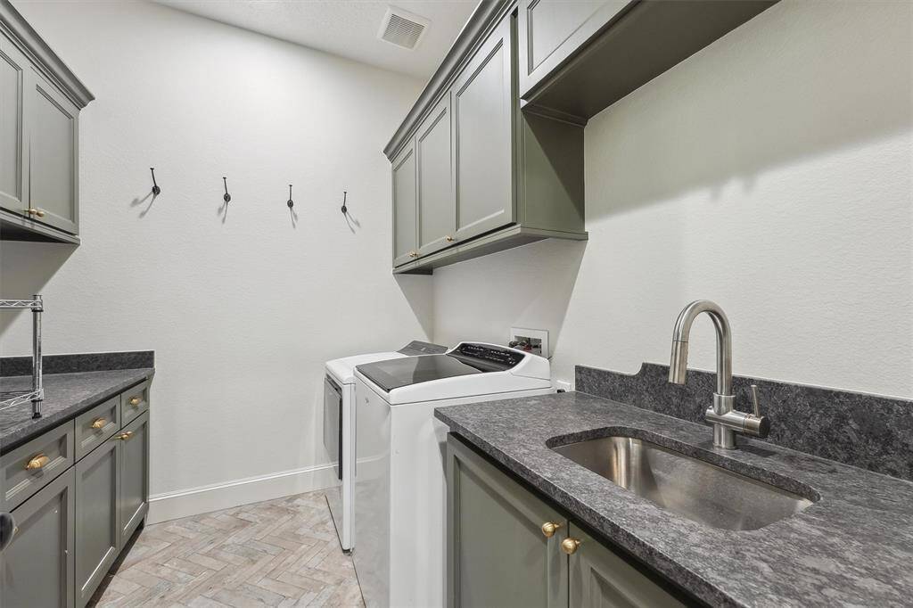 Large laundry room with matching leathered granite.