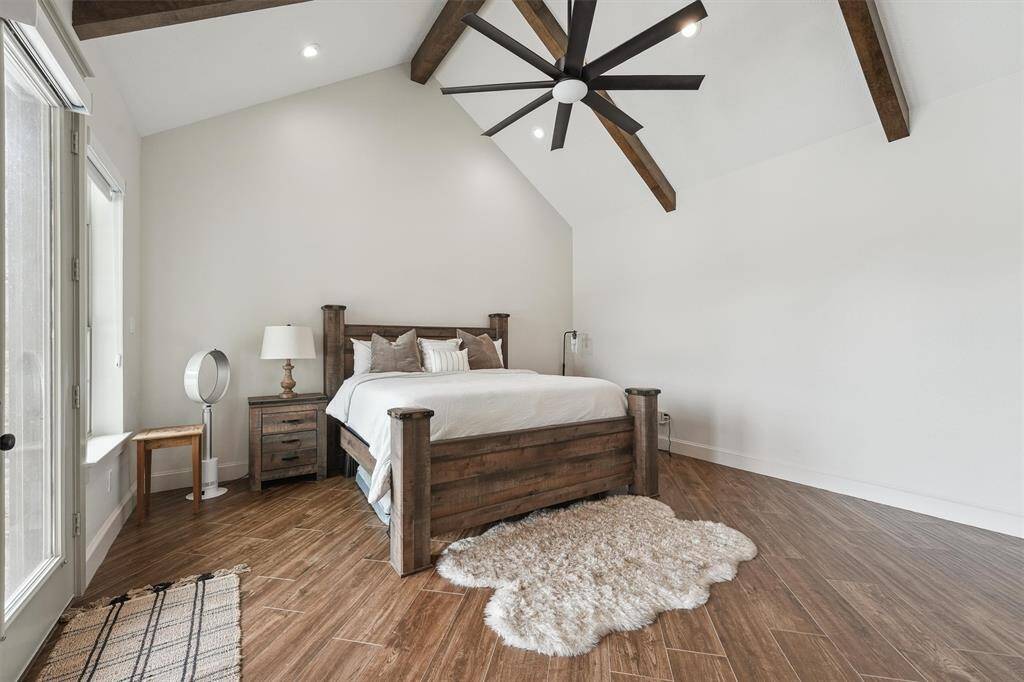 Primary suite with vaulted ceilings and private door to pool.