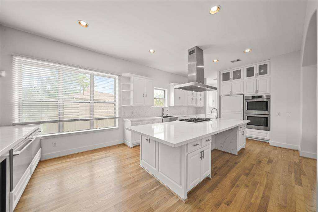 The Quartz Topped Island is Approximately 11'3" x 4'6" and offers a Wrap Around Breakfast Bar.  Additional Features in this Amazing Kitchen include Bosch Stainless Steel Double Ovens, Cabinet Faced Bosch Dishwasher, and a Cabinet Faced Built in Side by Side Sub Zero Refigerator.