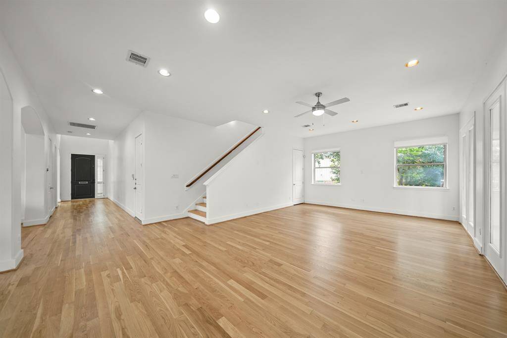 Picture Sized Windows in the Living Area view the Landscaped Side Yard.  The Living Area also offers Fresh Designer Paint, Updated Ceiling Fan with Light, and a Storage Closet with Built in Shelves (underneath the Stairwell).