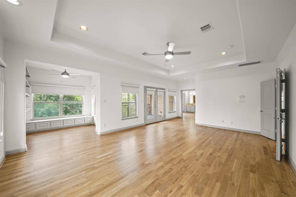 The Office/Flex Room is adjacent to the Primary Bedroom for your Convenience.  Fresh Designer Paint, Recessed Lighting, and a Ceiling Fan are also offered in the Spacious Primary Bedroom.  The French Door and Adjoining Stationary French Door opening to the Balcony are flanked by Picture Sized Windows.  Fabric Roller Shades provide Privacy for the French Door, Stationary French Door, and Windows.