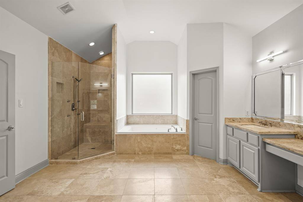 Relax in the Large Jetted Tub (Approximately 5' x 3'9") with Travertine Tile Surround, Polished Nickel Plumbing Fixtures, and Picture Sized Rain Glass Window.  The Large Walk in Frameless Glass Shower (Approximately 6'8" x 3'8") features Travertine Tile Surround, Travertine Topped Built in Shower Bench, Polished Nickel Hand Held Rain Shower Wand, Multiple Body Sprays, Dual Built in Shampoo Shelves, Angled Ceiling, Recessed Lighting, and Natural Stone Tile Flooring.