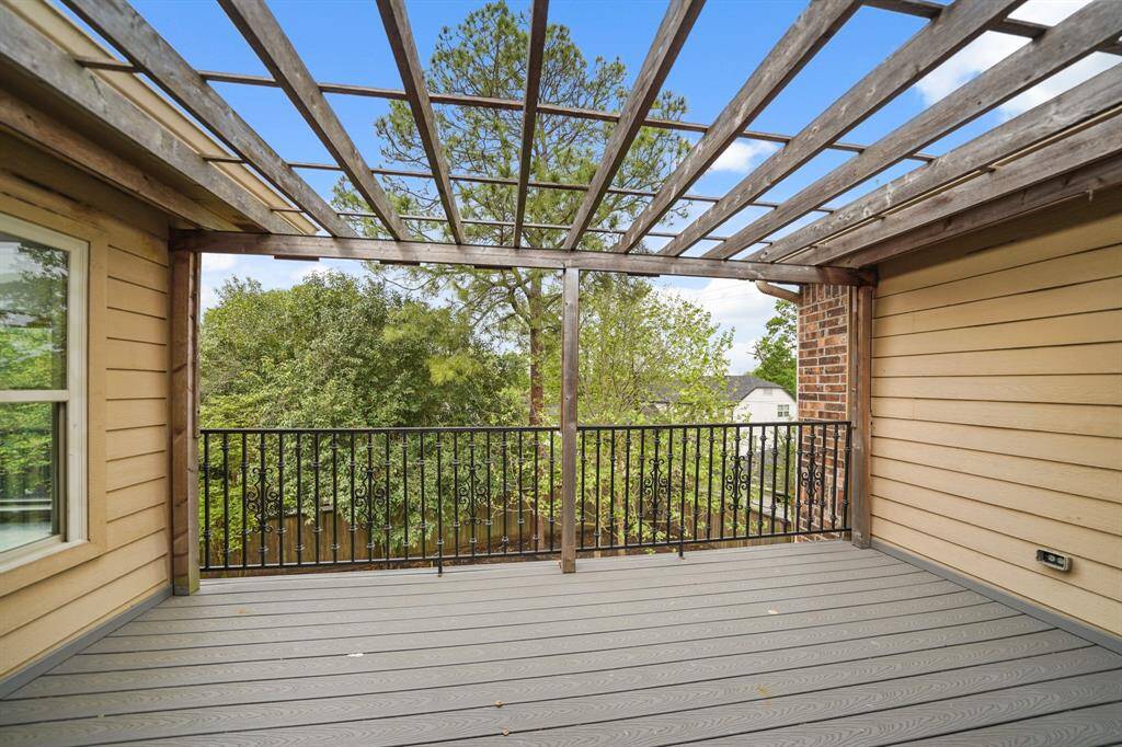 The Primary Suite features this Sunny Balcony with Composite Style Decking, Wrought Iron Railing, Arbor Cover, and Dual Coach Lights.  You'll enjoy Decorating this Private Balcony with your Favorite Potted Plants, Hanging Baskets, and Patio Lounging Furniture.