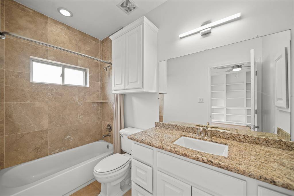 The Ensuite Bath to the Gameroom offers a Granite Topped Vanity, Fresh Designer Paint, White Porcelain Sink, Polished Cabinets and Drawers, 3 Light Polished Nickel Light Fixture, White Painted Wall Mounted Medicine Cabinet, Built in Medicine Cabinet, Kohler Commode, and Travertine Tile Floors.  A Full Tub/Shower with Travertine Tile Surround, Corner Built in Shampoo Shelf, Recesesd Light, and Slider Window are also featured in the Gameroom Ensuite Bath.