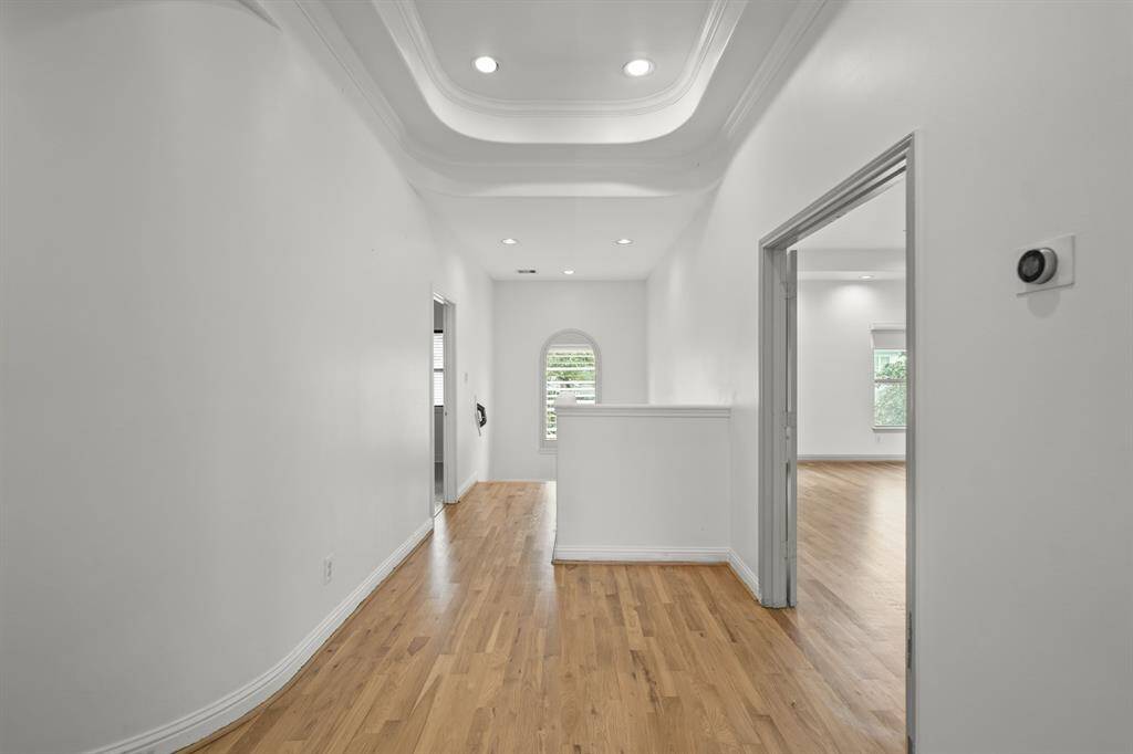 The Upstairs Landing (Approximately 10' x 8'10") features Brand New (April 2025) Refinished Natural Hardwood Floors and Architecturally Designed Curved Walls.  A Romeo and Juliet Arched Opening overlooks the Foyer.