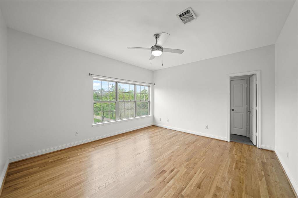 The Third Bedroom is Ensuite and features Brand New (April 2025) Refinished Hardwood Floors and Fresh Designer Paint.  A Ceiling Fan (with Light) and an Oversized Walk in Closet (Approximately 8' x 7'1") with Built in Shelves and Multiple Hanging Rods are also featured in the Third Bedroom.