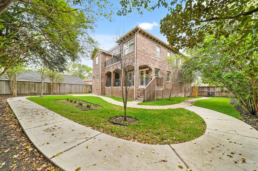 The Park-like Backyard offers a Concrete Walking Path, Privacy Fence, and Mature Magnolia Trees, Crepe Myrtles, etc.  Such a Relaxing View from the Outdoor Living Area!